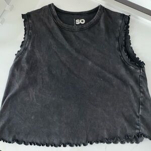 Top with ruffles on the arms and bottom. a light wash giving a distressed look